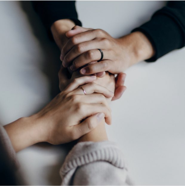 Two clients' hands interlocked